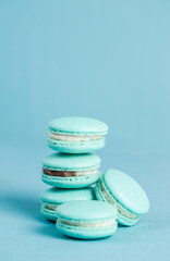 Blue handmade macarons on a blue  background