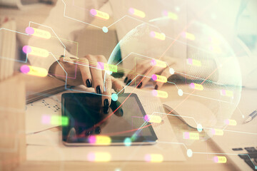 Double exposure of map sketch hologram and woman holding and using a mobile device.
