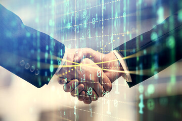 Double exposure of data theme hologram and handshake of two men. Partnership in IT industry concept.