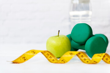 Diet Health food and lifestyle health concept. Sport exercise equipment workout with green apple...