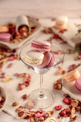 Colorful macarons in a glass, on a white background