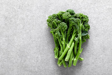 Broccolini. Fresh bunch of broccoli sprouts on a cooking table. Healthy food concept. Top down view