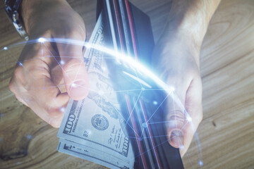 Multi exposure of social network theme drawing hologram and USA dollars bills and man hands.