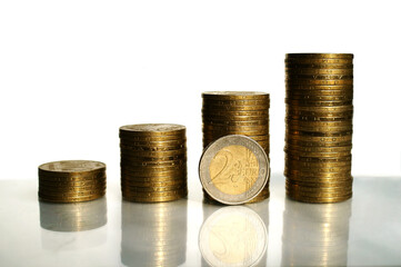 Columns of coins with euro coin