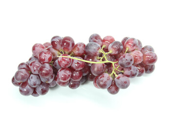 Fototapeta premium fresh purple grapes with a white background. Selective focus.