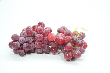 fresh purple grapes with a white background
