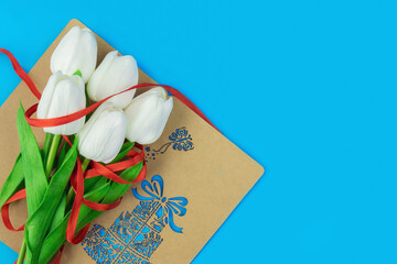 bouquet of white tulips on blue background