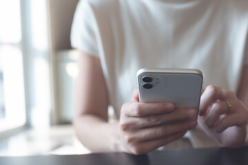 Closeup image of woman using mobile smart phone, social network concept