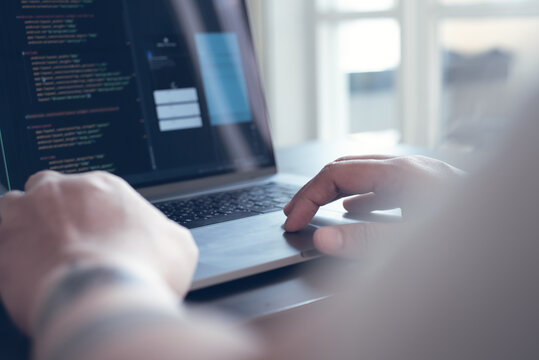 Digital software technology or mobile application development concept. Programmer, software developer coding, programming Javascript on laptop computer