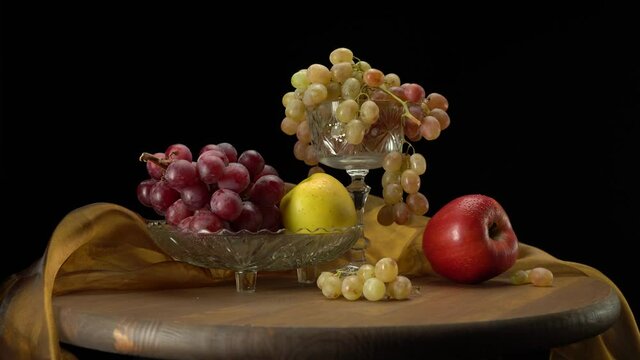 Apples and grapes on a black background.