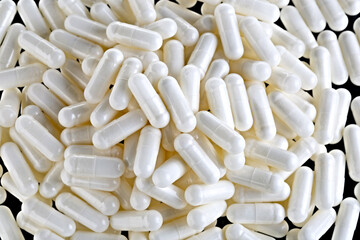Herbal medicine capsule for the treatment of virus and diseases. Photographed close-up on a black...