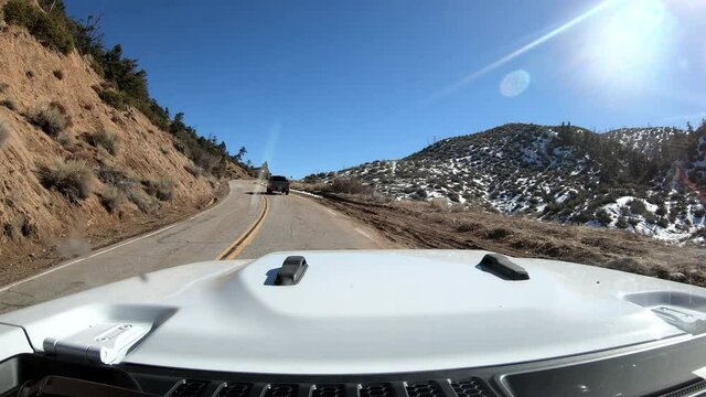 Dashcam view Driving Up Snow-Lined California Road in Winter