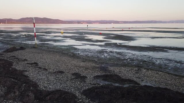November sunset in Marina Julia, the seaside of Monfalcone, Italy, during a low tide 