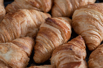 Background of lots of homemade croissants. Bakery. Food texture.
