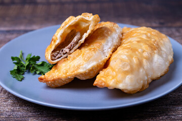 Chebureks with meat. Deep-fried flat pie. A traditional dish. Close-up.