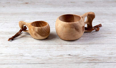 Traditional Sami wooden cups on a wooden table. Kuksa. Finnish wooden cups. Finnish culture.