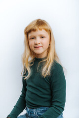 portrait of cute blonde girl against white background