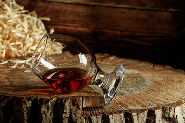 Whiskey with ice or brandy or rum in glass on rustic background. Whiskey with ice in a glass....