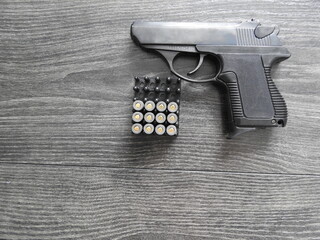 Small self-loading pistol-PSM 5.45 * 18 mm, with cartridges on a dark background
