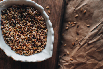 Organic food concept with flax seeds on a wooden background. Bowl with flax seeds.