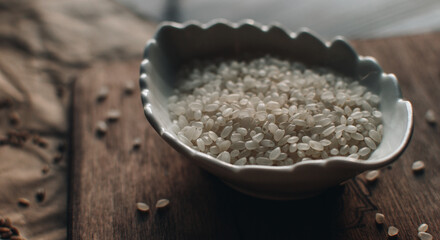 Organic food concept with white rice on a wooden background. Bowl with rice.