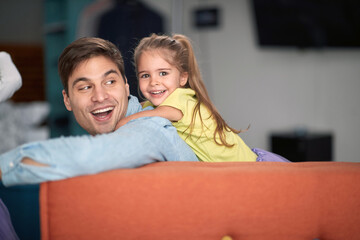 Joyful father and daughter playing together