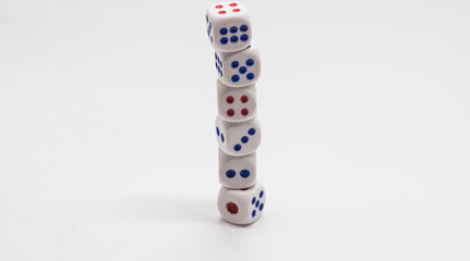 The cube is on the cube. Heap of white cubic dice with blue and red spikes (dots) on a white background. Game, gambling, chance and risk concept