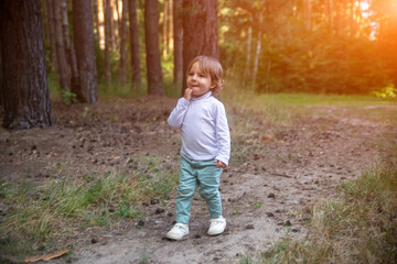 adorable toddler walks in the woods