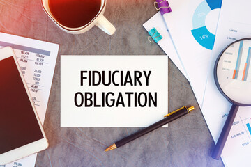 Fiduciary Obligation is written in a document on the office desk, coffee, diagram and smartfon