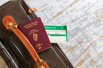 Irish passport with airplane boarding pass on suitcase. Concept travel to and from Ireland, Europe. National identification id