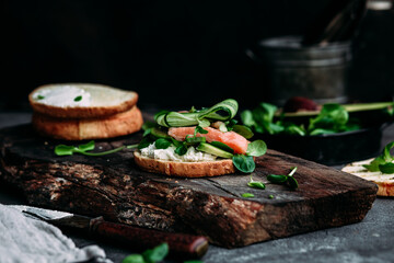 Sandwich with salmon, spinach, cream cheese, cucumber on a round toast
