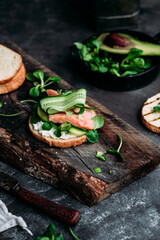 Sandwich with salmon, spinach, cream cheese, cucumber on a round toast