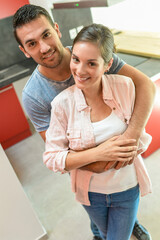 Fototapeta premium Portrait of a happy young couple in their kitchen