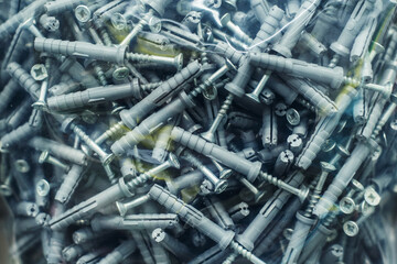 Dowels and screws in plastic packaging. Close-up