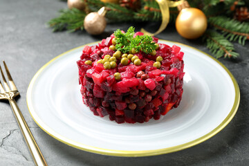 Traditional Russian salad vinaigrette served on grey table, closeup