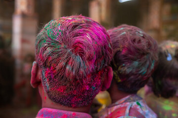 Closeup of people hair covered with color powder, holi festival celebration concept, background.