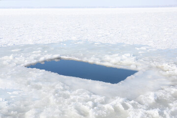Obraz premium Ice hole in river on winter day. Baptism ritual