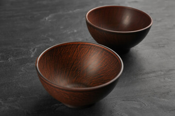 Beautiful empty clay bowls on black table