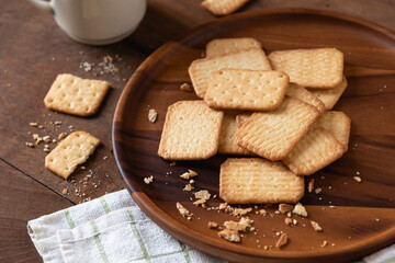 Homemade crackers stack on wooden plate for coffee break