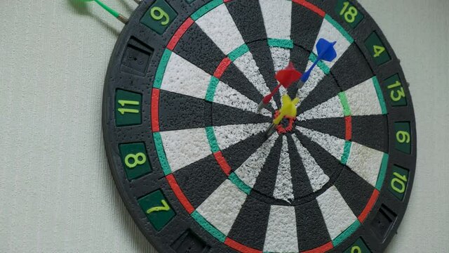 Throwing three darts into the target aim and missing a ten points circle. making mistakes, failure leads to success, imperfection achieving goals concept 4k UHD video