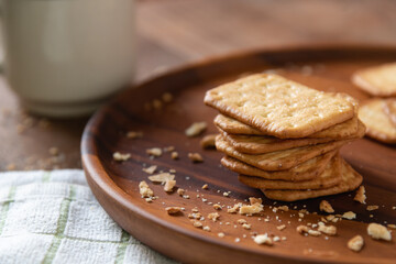 Fototapeta na wymiar Homemade crackers stack on wooden plate for coffee break