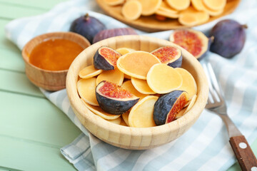 Plate of tasty pancakes with fresh figs and honey on table, closeup