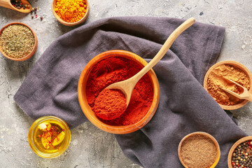 Bowls with different spices on dark background