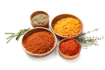 Bowls with different spices and herbs on white background