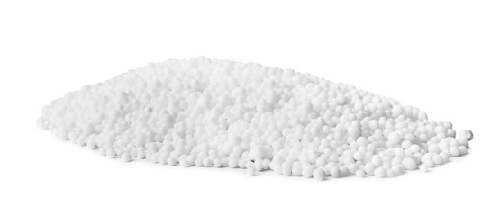 Pellets of ammonium nitrate on light grey background. Mineral fertilizer