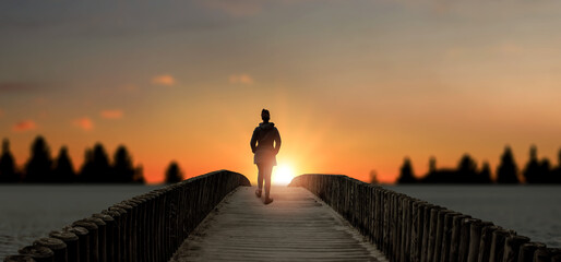 a girl stands on bridge lake sunset.