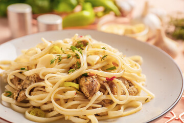 Plate with tasty noodles and chicken on color background, closeup