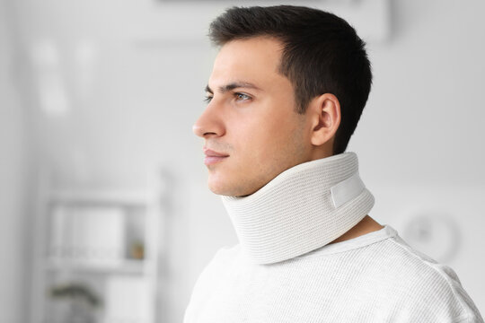 Young Man With Cervical Collar On Neck At Home