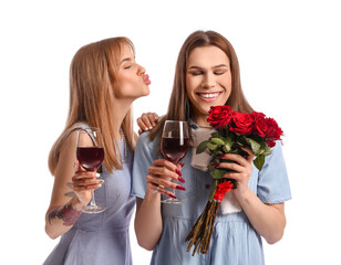Young transgender couple with glasses of wine and flowers on white background. Valentine's Day celebration