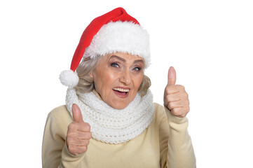 Portrait of senior woman in Santa hat showing thumbs up